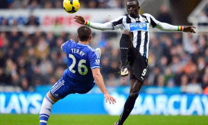 Chelsea John Terry and Newcastle United Papiss Cisse battle for the ball
