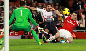 Liverpool Luis Suarez and Arsenal Laurent Koscielny in action